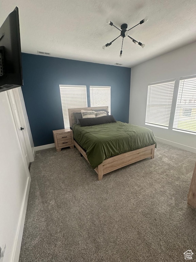 40 E 200 N, Castle Dale, UT 84513 - bedroom with multiple windows, a textured ceiling, carpet floors, and ceiling fan