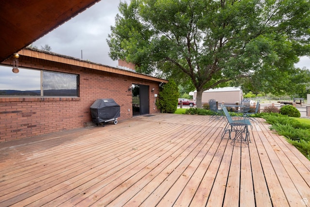 wooden deck featuring area for grilling