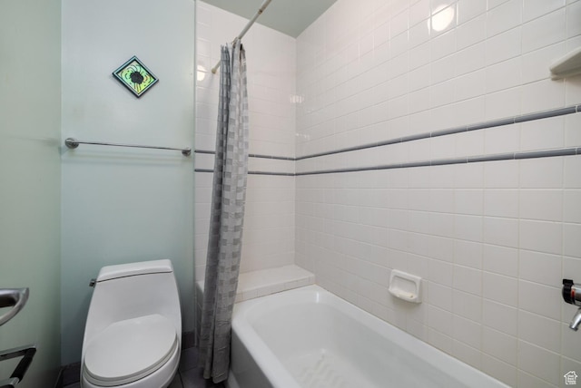 bathroom featuring shower / tub combo and toilet