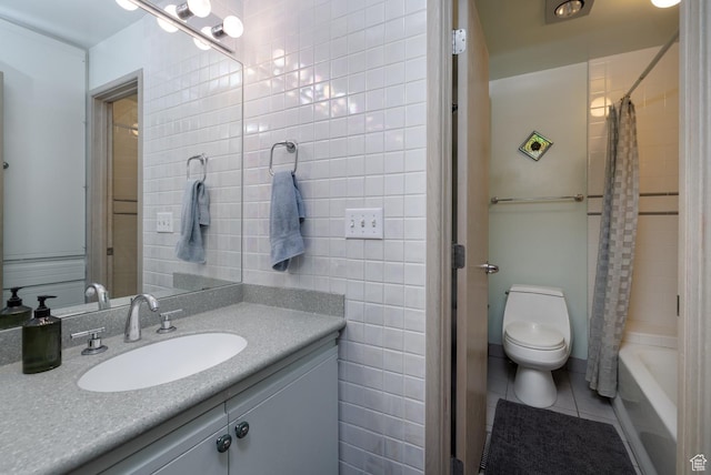 full bath with vanity, tile walls, toilet, tile patterned flooring, and shower / bath combo with shower curtain