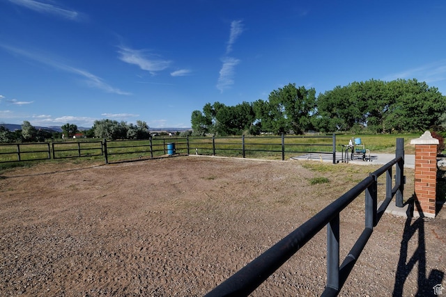 view of yard with a rural view and an enclosed area