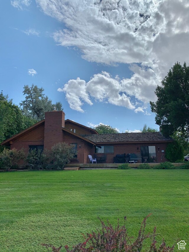 exterior space featuring a lawn and a chimney