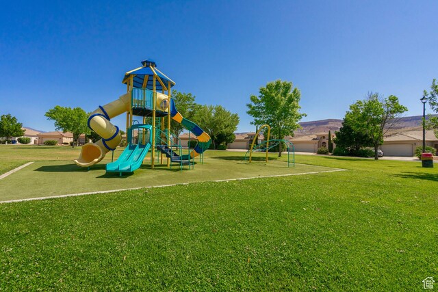 view of playground with a lawn