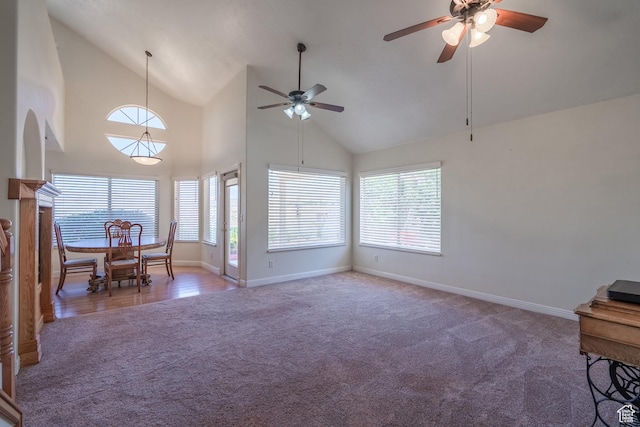 living room featuring ceiling fan, carpet floors, and high vaulted ceiling