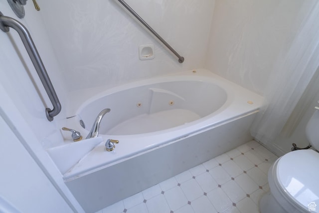 bathroom with a washtub and toilet