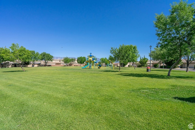 surrounding community featuring a playground and a yard