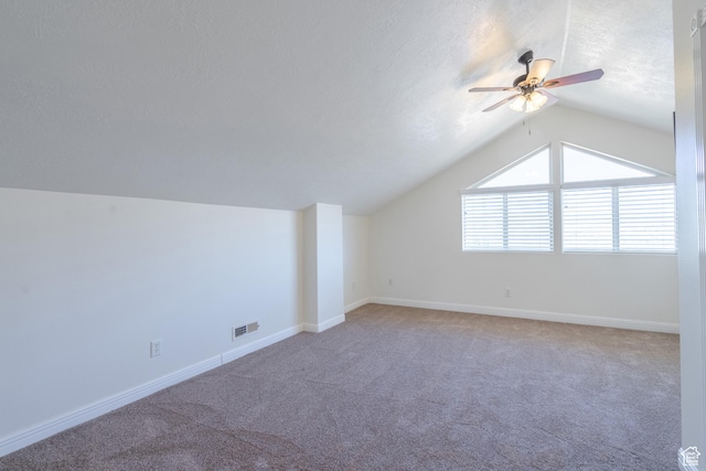 bonus room with a textured ceiling, carpet floors, ceiling fan, and lofted ceiling