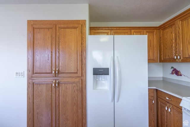 kitchen featuring white fridge with ice dispenser
