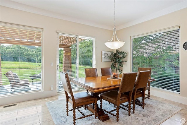 dining space with crown molding, visible vents, light tile patterned flooring, and plenty of natural light