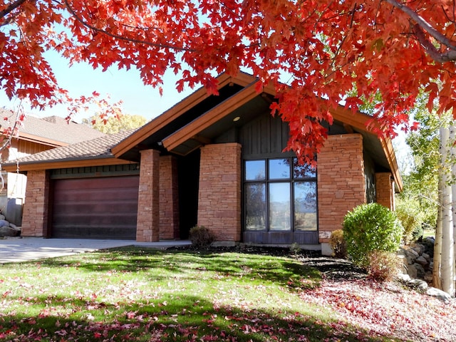 4859 E Eagleridge Dr, Eden, UT 84310 - view of front of home with a garage, driveway, stone siding, and a front lawn