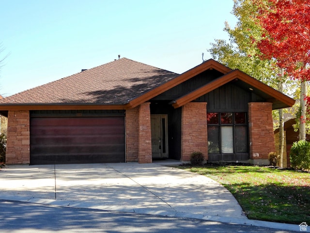 4859 E Eagleridge Dr, Eden, UT 84310 - view of front facade featuring a garage, concrete driveway, roof with shingles, and stone siding
