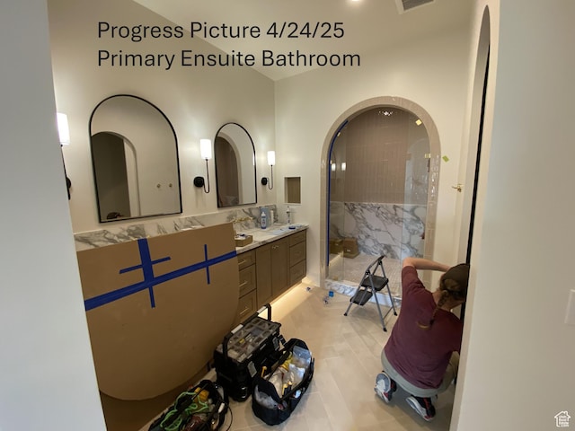 full bath featuring vanity, tile patterned flooring, and a stall shower
