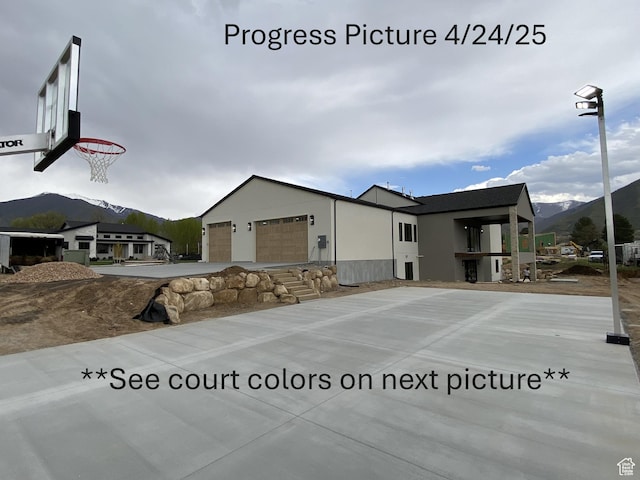 exterior space with an attached garage and a mountain view