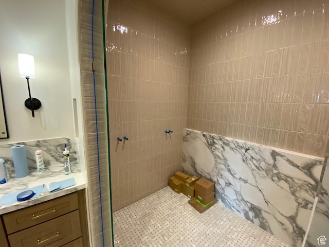 bathroom with vanity and tiled shower