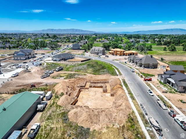 drone / aerial view featuring a residential view and a mountain view