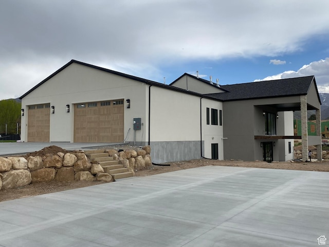 exterior space featuring stucco siding and a garage