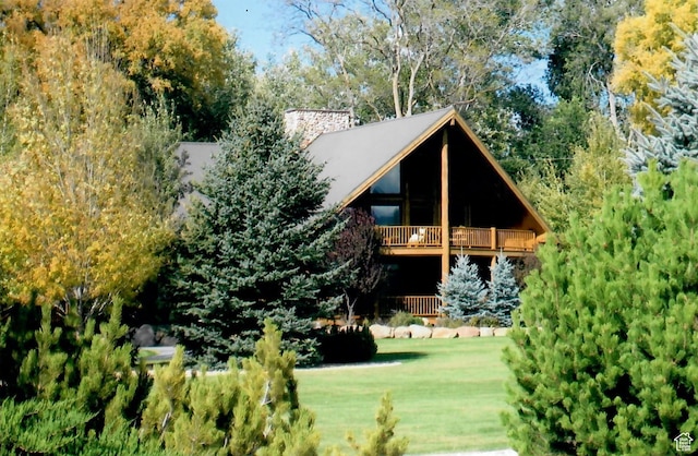 exterior space with a wooden deck and a lawn