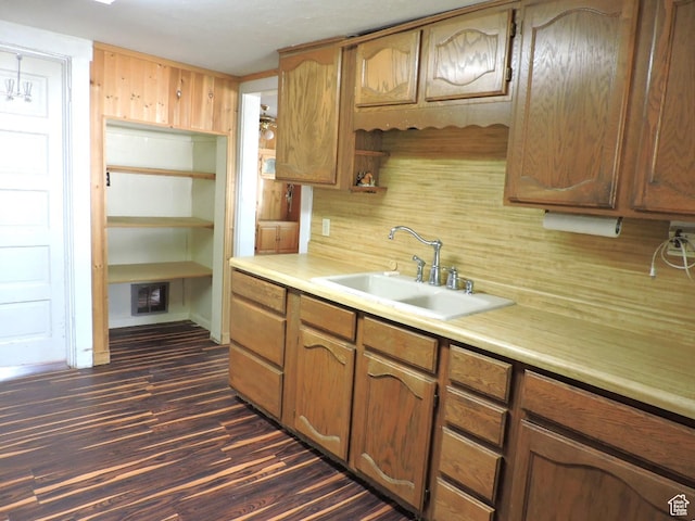 kitchen featuring sink and dark wood-type flooring