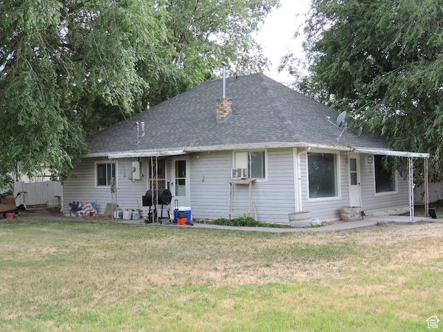 rear view of house with a lawn