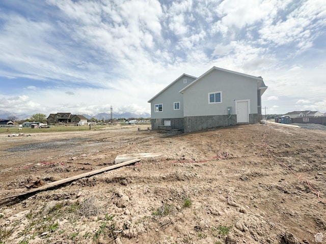 view of side of home featuring stucco siding