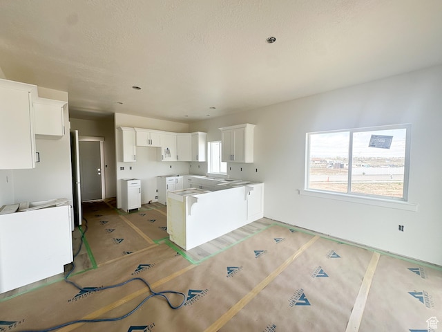 kitchen featuring white cabinets and visible vents