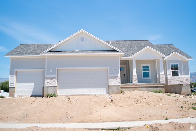 3634 S Macy Ln, West Haven, UT 84401 - craftsman-style house with an attached garage, covered porch, stone siding, roof with shingles, and board and batten siding