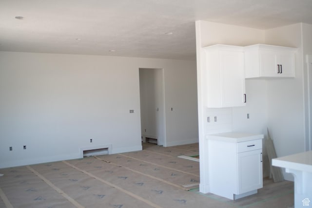3634 S Macy Ln, West Haven, UT 84401 - kitchen featuring white cabinetry, light countertops, and baseboards
