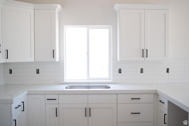 3634 S Macy Ln, West Haven, UT 84401 - kitchen featuring white cabinets and backsplash