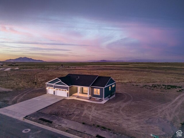1076 N Windflower Ln W Unit 125, Grantsville, UT 84029 - aerial view at dusk featuring a mountain view