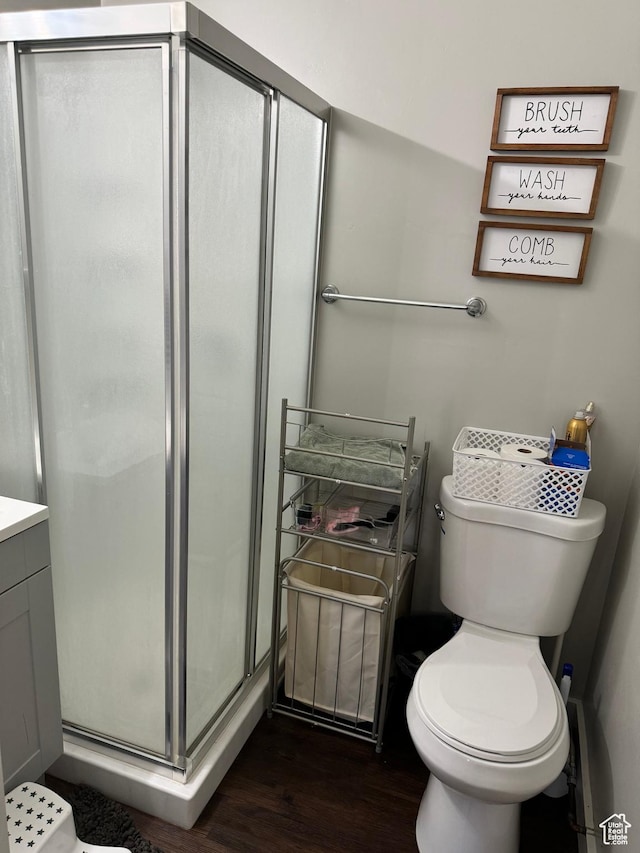 339 Berkley Ave, East Carbon, UT 84520 - full bath with a shower stall, wood finished floors, vanity, and toilet
