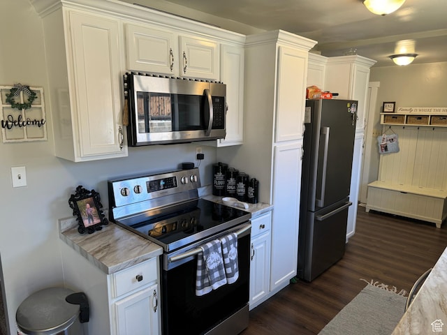 339 Berkley Ave, East Carbon, UT 84520 - kitchen with stainless steel appliances, white cabinetry, and dark wood finished floors