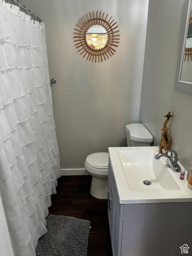 339 Berkley Ave, East Carbon, UT 84520 - bathroom featuring baseboards, curtained shower, toilet, vanity, and wood finished floors
