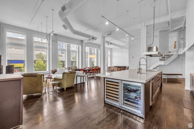 159 W Broadway Unit 301, Salt Lake City, UT 84101 - kitchen featuring dark hardwood / wood-style flooring, rail lighting, a kitchen island with sink, sink, and pendant lighting