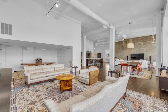159 W Broadway Unit 301, Salt Lake City, UT 84101 - living room featuring a towering ceiling and hardwood / wood-style flooring
