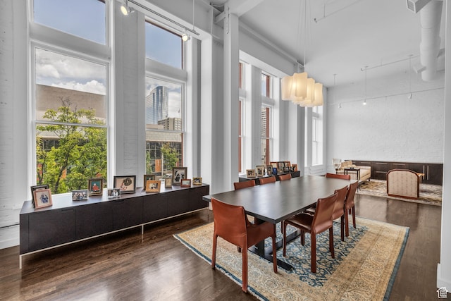 159 W Broadway Unit 301, Salt Lake City, UT 84101 - dining space featuring dark wood-type flooring and a high ceiling