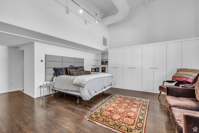 159 W Broadway Unit 301, Salt Lake City, UT 84101 - bedroom with a towering ceiling, dark wood-type flooring, and track lighting