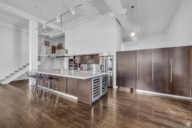 159 W Broadway Unit 301, Salt Lake City, UT 84101 - kitchen with a high ceiling, dark wood-type flooring, track lighting, and wine cooler