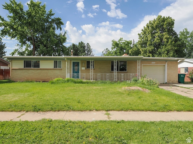 single story home with a garage and a front lawn