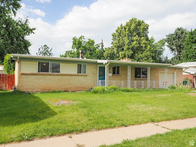 ranch-style house with a garage and a front lawn