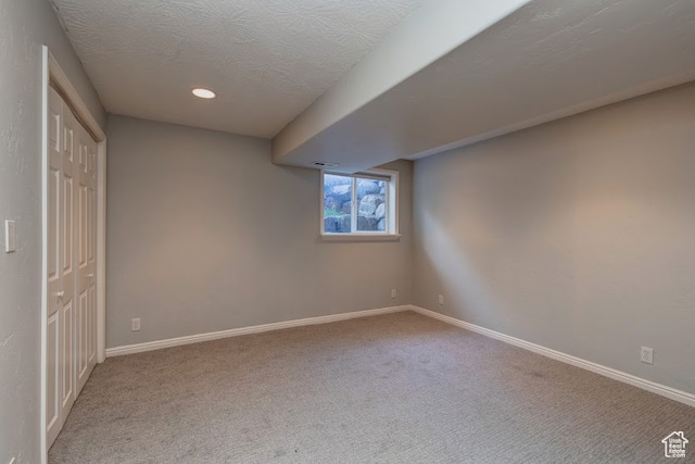 interior space featuring carpet and a textured ceiling