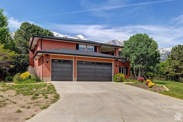 view of property with a garage and a mountain view