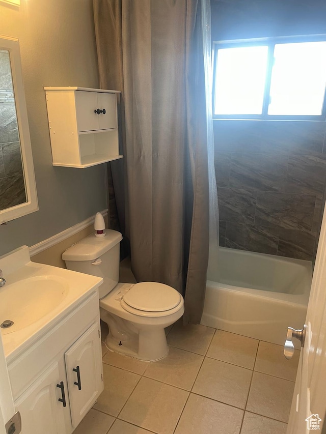 full bathroom featuring toilet, shower / bath combo with shower curtain, tile patterned flooring, and vanity