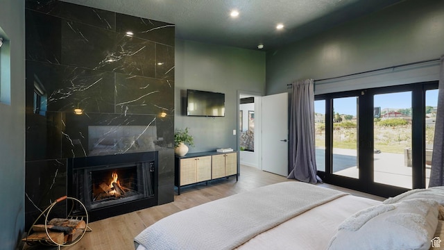 1245 E Draper Ln, Wallsburg, UT 84082 - bedroom with a high end fireplace, wood-type flooring, a towering ceiling, and access to outside