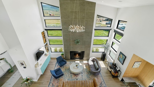 1245 E Draper Ln, Wallsburg, UT 84082 - living room with a tile fireplace, a high ceiling, and light hardwood / wood-style flooring