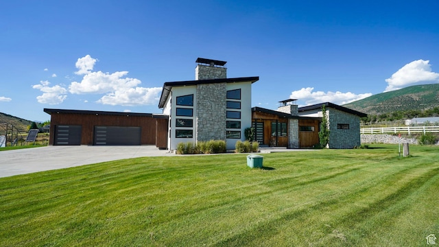 1245 E Draper Ln, Wallsburg, UT 84082 - contemporary house with a mountain view, a garage, and a front lawn