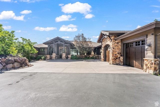 1355 W Red Hawk Trl Unit 35, Park City, UT 84098 - exterior space featuring a garage, driveway, and stone siding