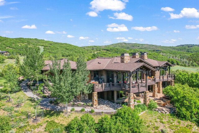 1355 W Red Hawk Trl Unit 35, Park City, UT 84098 - back of house featuring a chimney, a wooded view, and a wooden deck