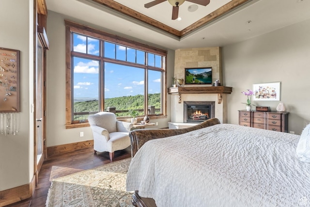 1355 W Red Hawk Trl Unit 35, Park City, UT 84098 - bedroom with a raised ceiling, a fireplace, wood finished floors, and baseboards