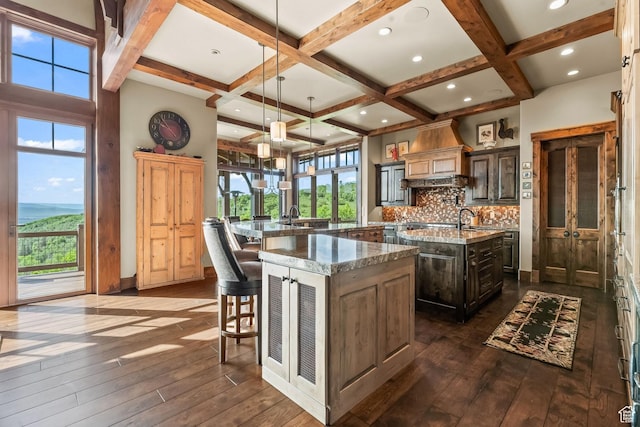 1355 W Red Hawk Trl Unit 35, Park City, UT 84098 - kitchen featuring a spacious island, dark wood-style flooring, coffered ceiling, and tasteful backsplash