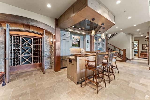 1355 W Red Hawk Trl Unit 35, Park City, UT 84098 - bar featuring recessed lighting, stairs, hanging light fixtures, backsplash, and stone tile flooring